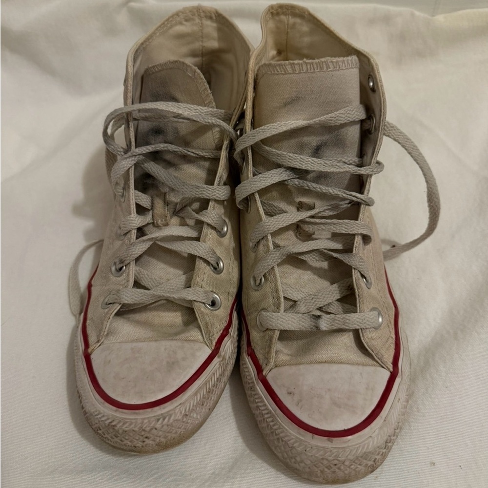 Very well worn white high top Converse